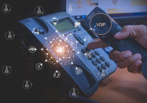 Hand of man using ip phone with flying icon of voip services and people connection, voip and telecommunication concept